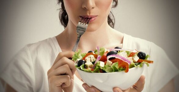 lány, aki egy tányér salátát tart